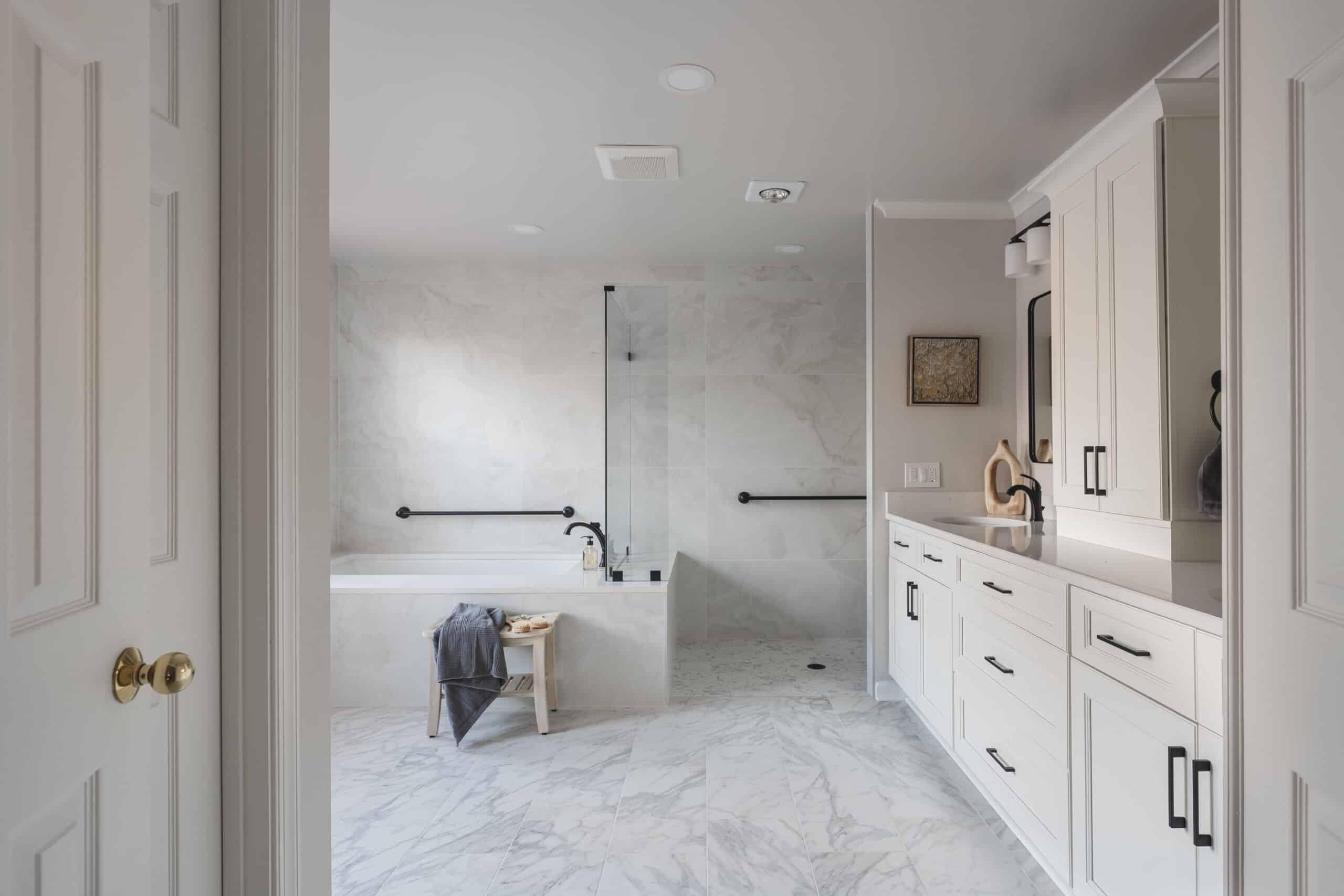 Warm bathroom with layered lighting, clean vanity, and elegant shower design