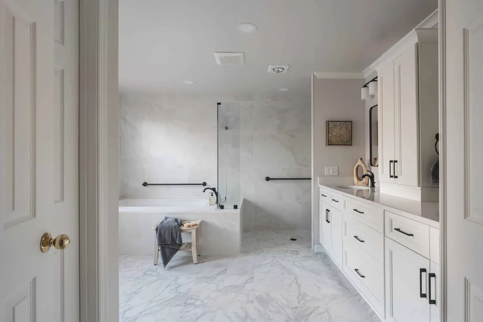 Master bathroom remodeling project in Centreville with a tub, shower, and bright cabinetry