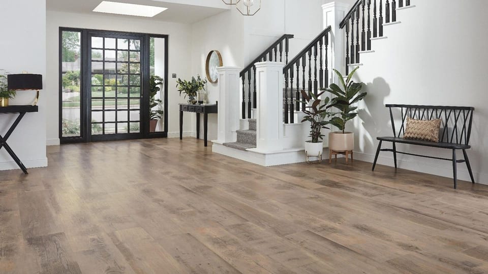 Warm flooring and transition detail representing construction coordination for a home addition